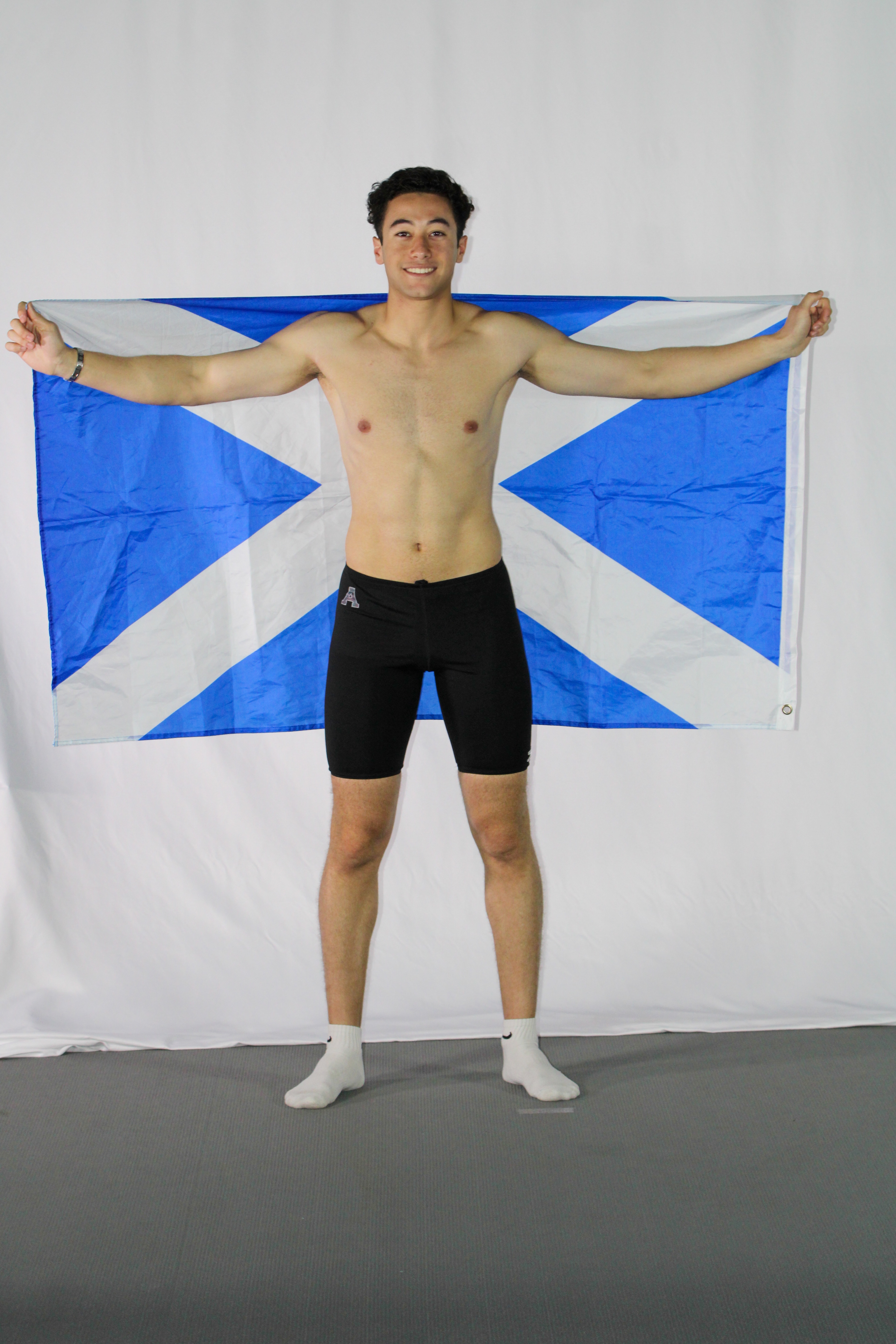 Rayane holding Alma flag in swim gear